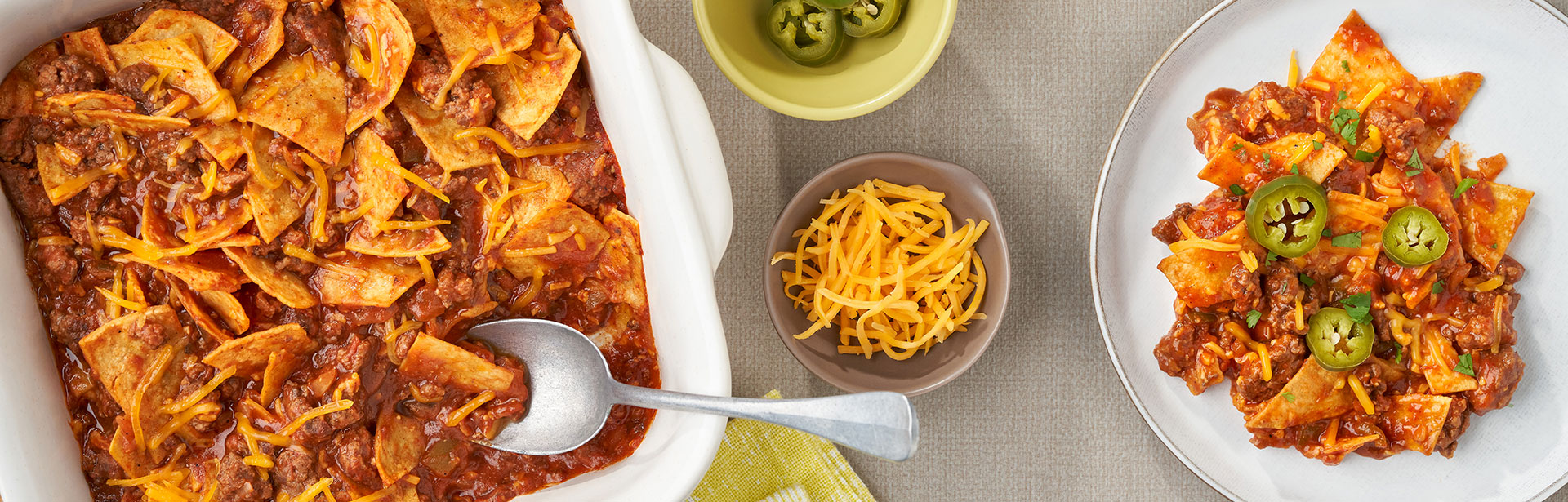 An image of prepared Easy Beef Taco Bake showing ground beef, Campbell's® Condensed Tomato Soup, Pace® Picante Sauce, corn or flour tortillas and melted Cheddar cheese.