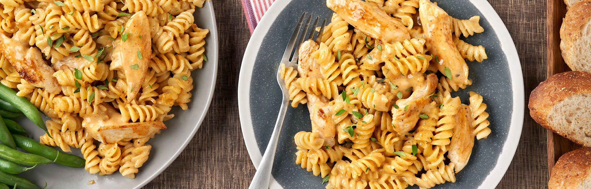 An image of prepared Creamy Chili Chicken Pasta showing rotini pasta, chicken, Campbell's® Condensed Cream of Chicken Soup and Parmesan.