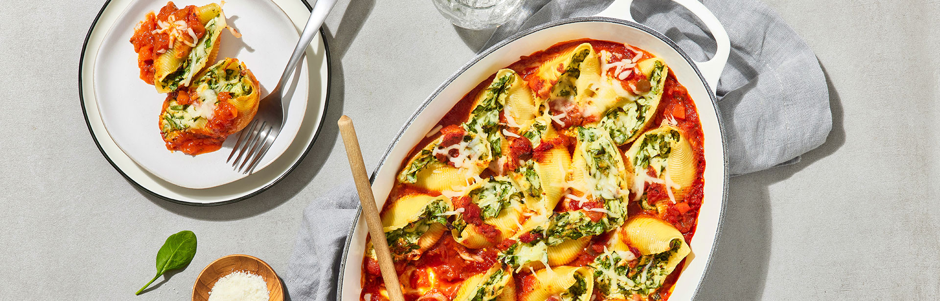 An image of prepared Spinach & Cheese Stuffed Shells made with pasta shells, baby spinach, ricotta cheese, mozzarella cheese, Parmesan cheese and Prego® Italian Sauce.