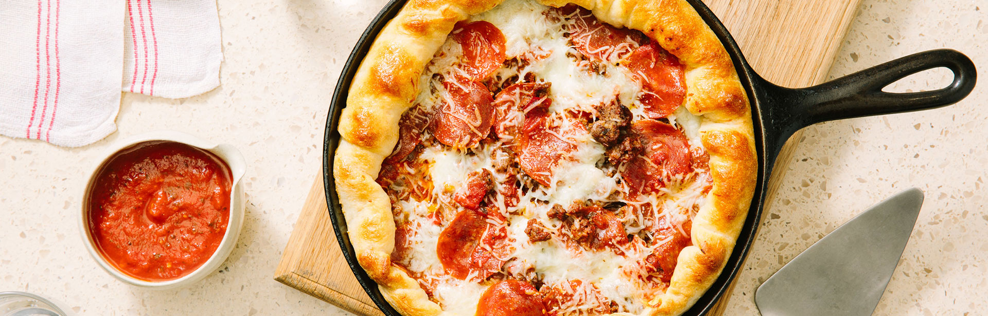 An image of prepared Homemade Deep Dish Pizza with Beef, Pepperoni & Peppers made with ground beef, peppers, onions, Prego® Traditional Sauce, pepperoni and pizza cheese blend.